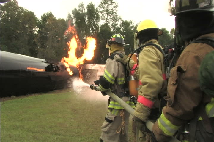 Closeup footage of Firefighters battling a train wreck fire 