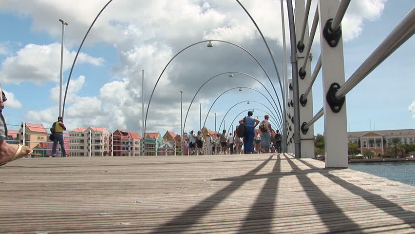 Unrecognizable people walking on pontoonbridge in Willemstad, Curacao, Netherlands Antilles.