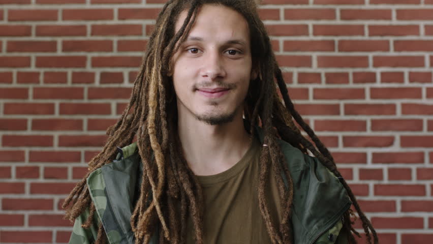 Portrait Of Attractive Young Mixed Race Man With Dreadlocks Laughing