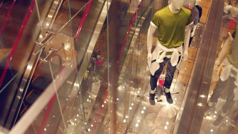 View through window to modern concept manikins at the store. Government manipulation concept.