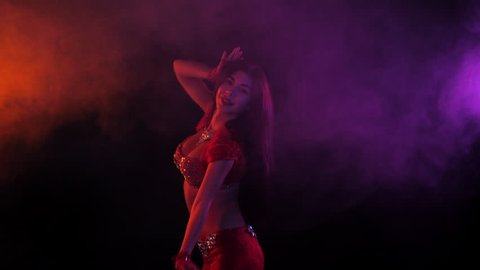 Hot Nude Orient Beach - Tempting sexy traditional oriental belly dancer girl dancing on purple neon  smoke background. woman in exotic red costume sexually moves her semi-nude  body. 4k.