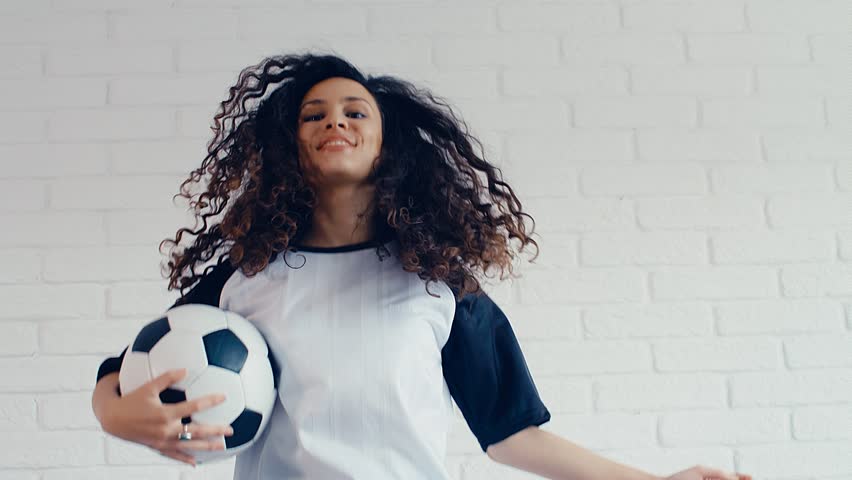 Young Woman With Curly Hair In Football Soccer Outfit Jumping 4k 75