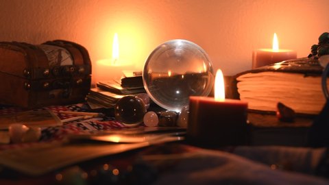 Background Of A Fortune Teller Table Covered With Fabric With Crystal Balls Stones Matches Cards Ancient Books Rings And Candles With Flickering Flames