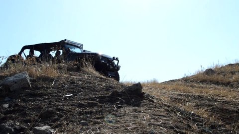 Erebuni Armenia 03 July 2019 Custom Fully Off Road Black Jeep Wrangler Without Doors And Roof Cruising On The Hills Surrounded With Yellow Grass Outside Of Road