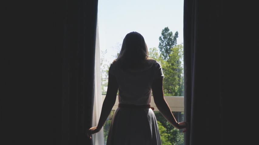 Woman Opening Curtains In The Hotel Room