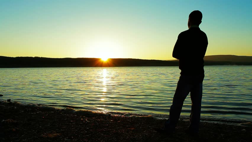 Young Man Praising And Worshiping God During Sunset By The Sea Stock ...