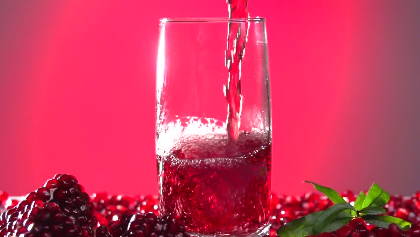 Garnet. Pomegranate Juice Is Poured Into A Glass. Slow Motion 240 Fps. High Speed Camera Shot ...