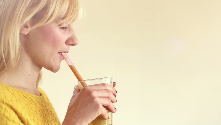 Close Up Of Profile Face Of A Young Woman Drinking Smoothie In Slow Motion Close Up Of Profile Face Of A Young Woman Drinking Smoothie In Slow Motion
