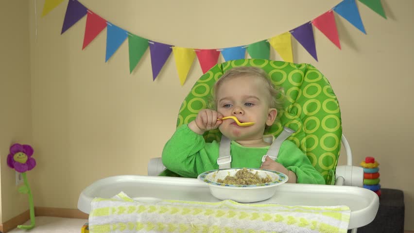 One Year Old Baby Eating Stock Footage 100 Royalty Free One Year Old Baby Eating Porridge With Messy Face Adorable Toddler Girl Sitting In Highchair Having Breakfast From Bowl Spoon Static Closeup Shot
