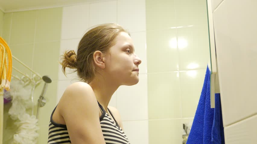 Beauty Teenage Girl Applying Make Up And Admiring Herself