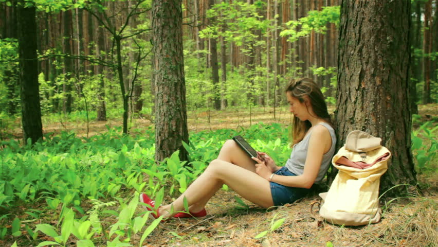 Beautiful Girl In The Woods For A Walk Sitting Under A Tree And Read Tablet Pc Video Is 7108