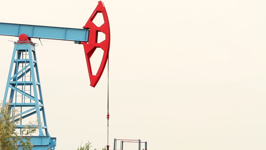 Working Oil Pump In A Field On Bright Background Working Oil Pump In A Field On Bright Background