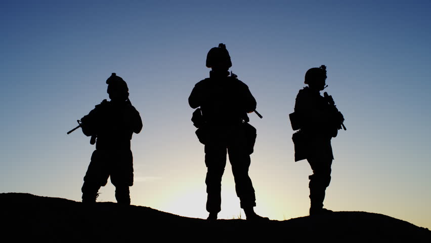 Squad Of Three Fully Equipped And Armed Soldiers Standing On Hill In 