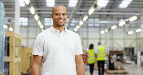 4k, Portrait of a cheerful and friendly African American male warehouse manager. Slow motion.