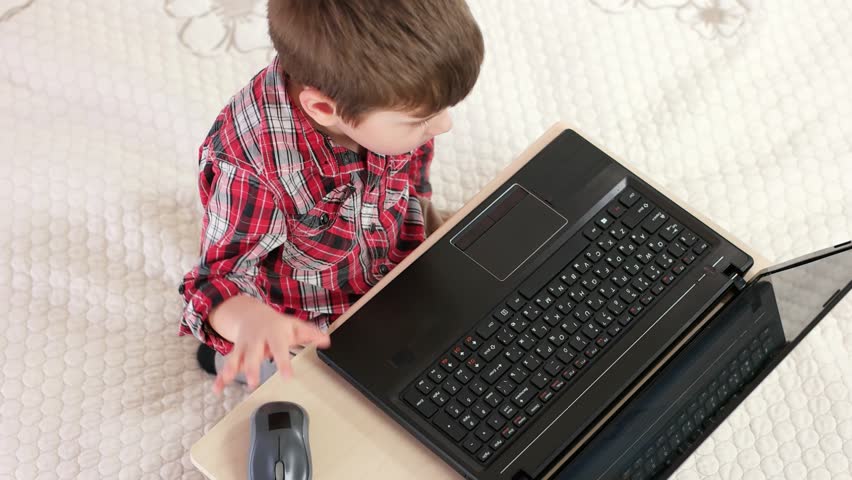 Little Boy Using Laptop Computer, Smart Kid Lying On Bed And Playing Pc ...