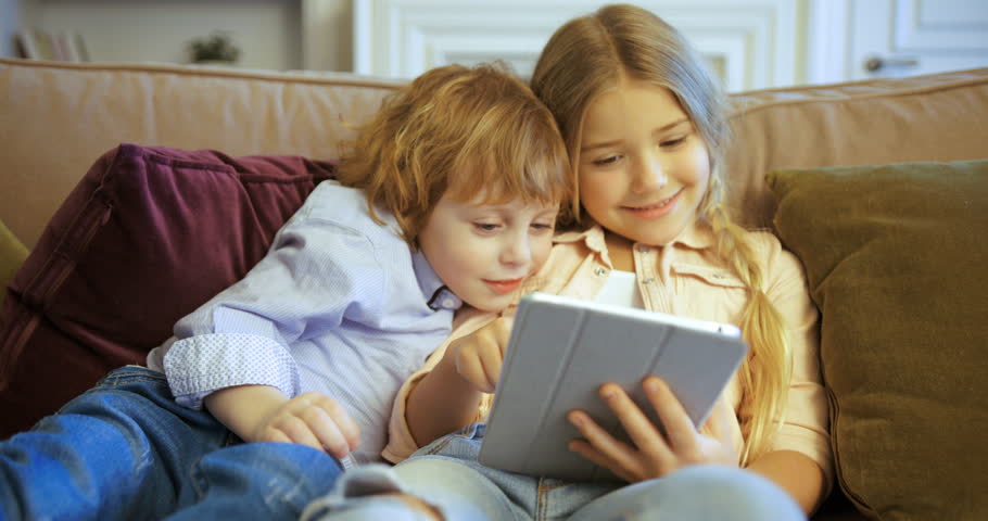 Happy Brother And Sister Playing On Tablet Device Cute Kids Playing