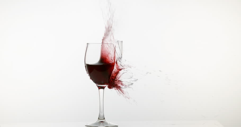 Glass Of Red Wine Falling And Splashing Against White Background, Slow