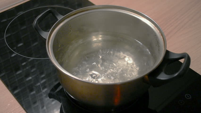 Hd00 29boiling Water In A Metal Saucepan On A Black Induction Cooker