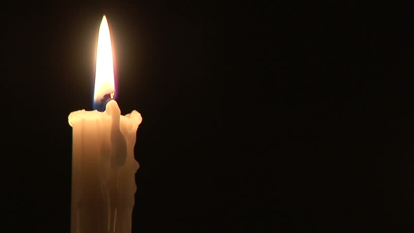 Loop With Single Simple White Candle And Flickering Flame Against A