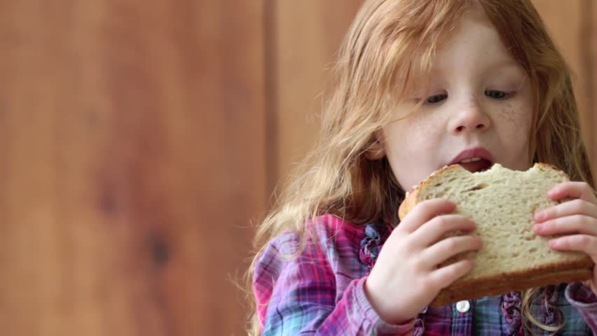 Hd00 15redheaded Girl Eating Peanut Butter And Jelly Sandwich