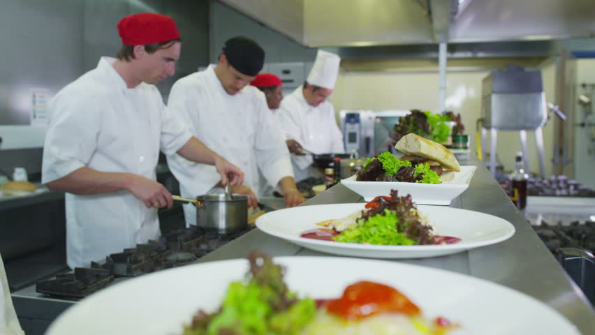 Restaurant Kitchen Video professional chefs in a restaurant or hotel kitchen. they are Restaurant Kitchen Video professional chefs in a restaurant or hotel kitchen. they are