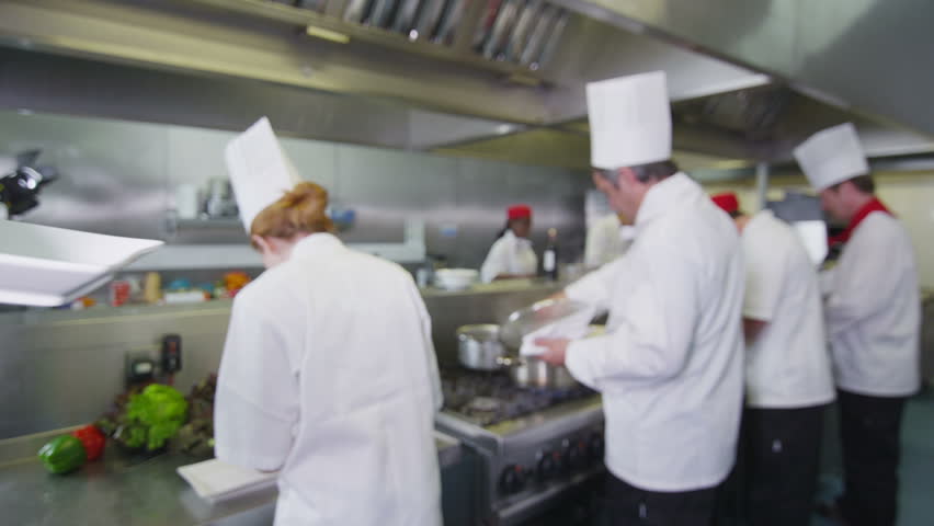 Restaurant Kitchen Video waitress collects her order from the chef in a busy hotel or Restaurant Kitchen Video waitress collects her order from the chef in a busy hotel or