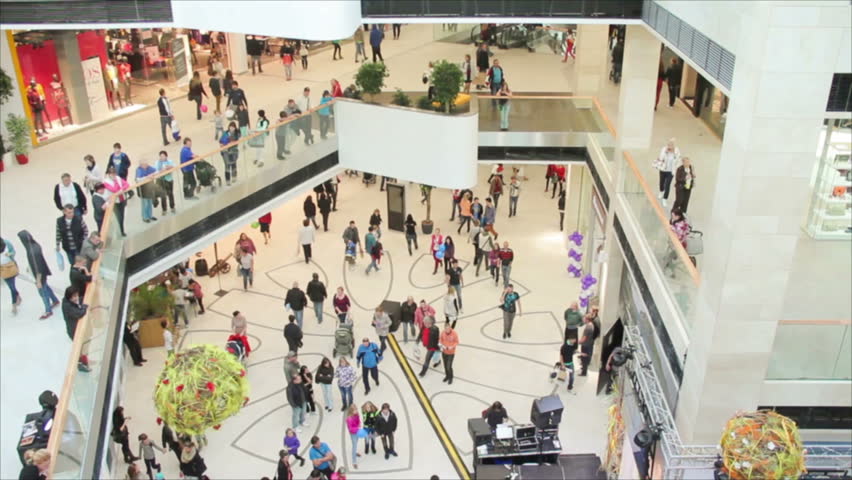 Slightly defocused crowd of walking people in the newly opened shopping mall