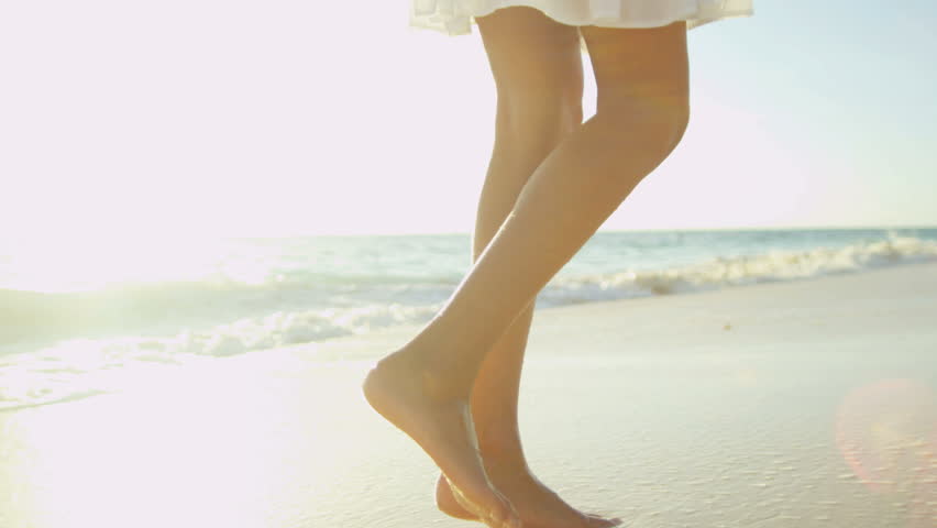 Legs Only Young Ethnic Girl Walking Barefoot Along Wet Sand Beach