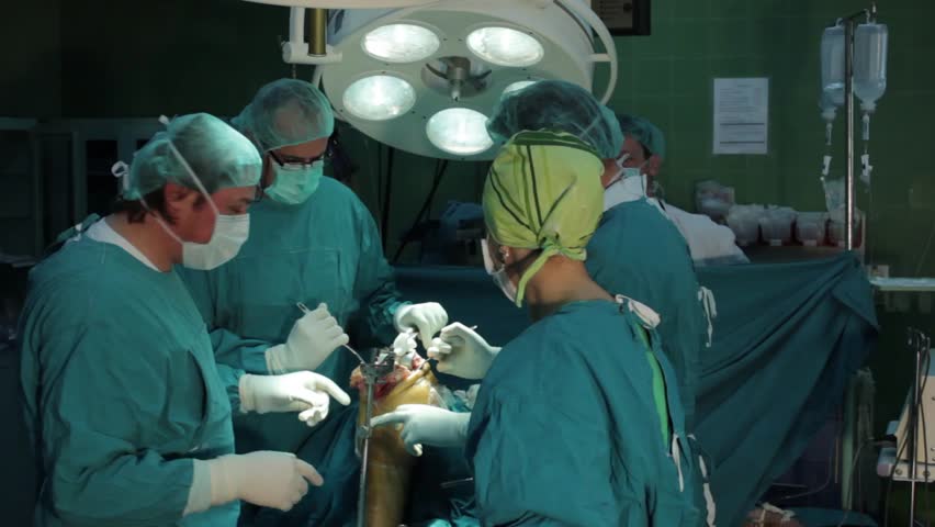 Surgeons Team Preforming Operation In Hospital Operating Theater ...