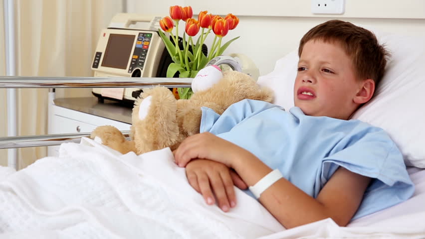 little-sick-boy-sleeping-in-bed-with-teddy-bear-in-the-hospital-ward