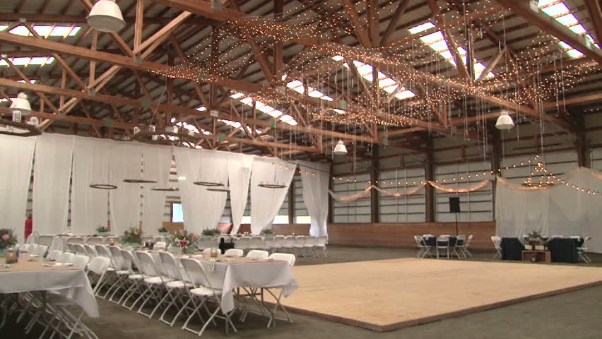 Camera Tilt Down Interior Barn Arena With Wedding Reception Setting