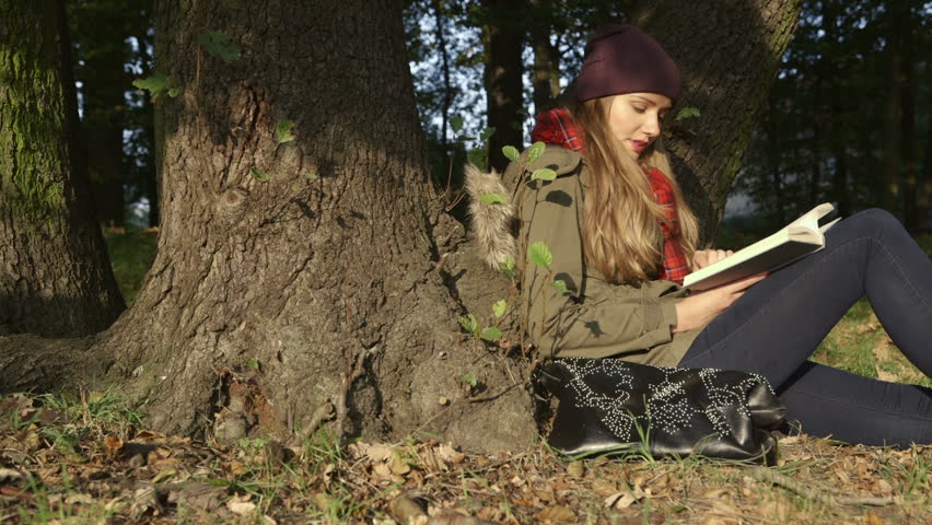 Woman Relaxing In Autumn Fall Park Steadicam. Young Girl In Hat Holding ...