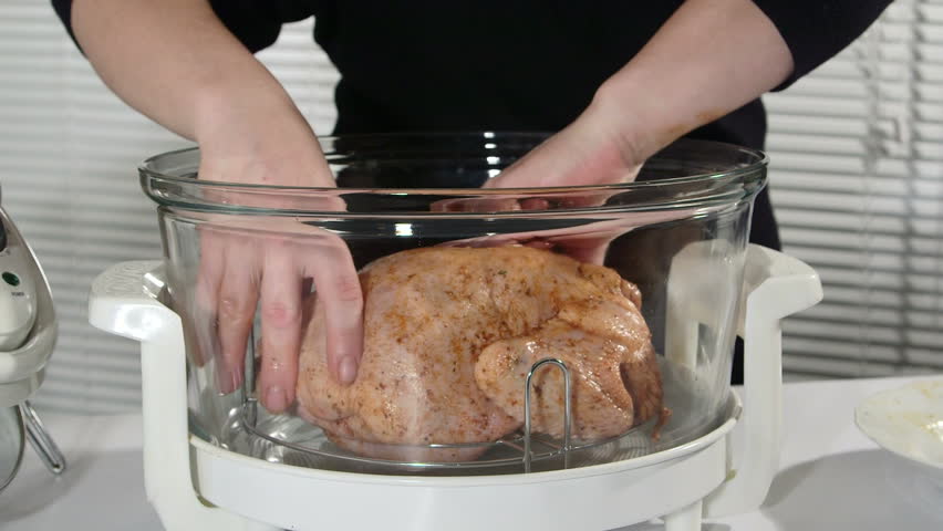 Woman Cooking Whole Roasted Chicken In Convection Countertop Oven