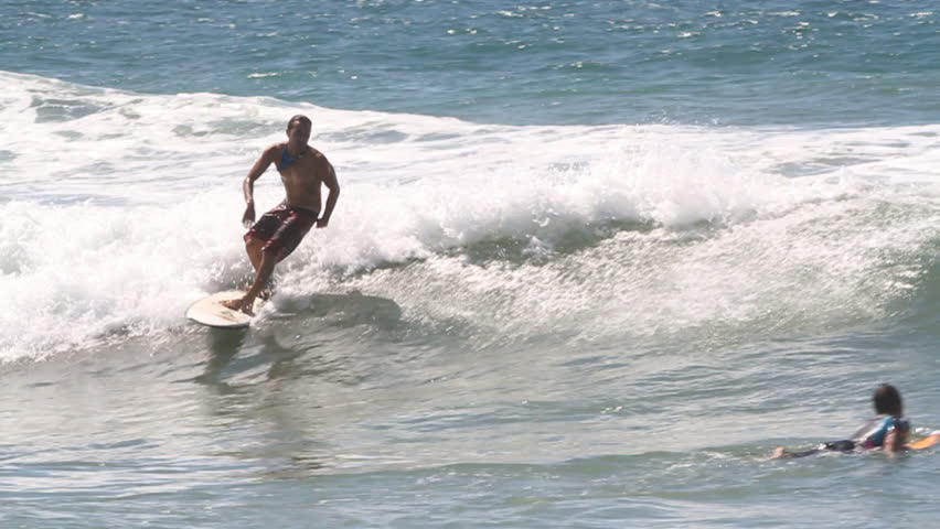 A Surfer Riding Small Waves Stock Footage Video 100 Royalty Free 8303194 Shutterstock