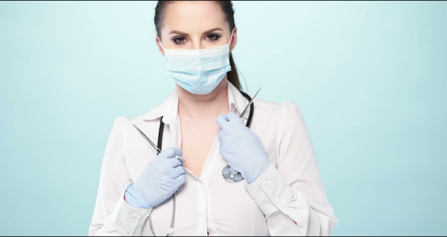 Video Of Sexy Nurse Wearing Mask On Blue 4K Stock Footage -1560