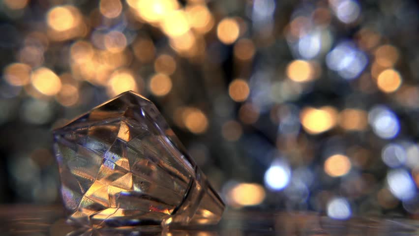 Stock video of rotating diamond and colorful blurry background ...
